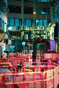 Empty chairs in city at night