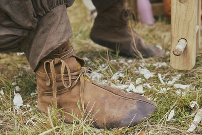 Retro photo. leather boots of a carpenter working in the yard
