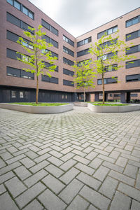 Residential building by street against sky