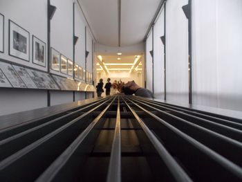 People walking on illuminated corridor