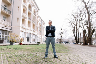 Confident business man standing in the city, looking and dreaming of future business success