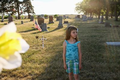 Full length of cute girl at cemetery