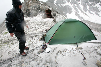 Full length of man standing by tent during winter