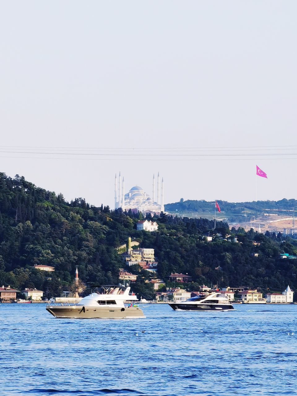 SAILBOAT IN SEA AGAINST CLEAR SKY