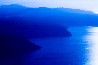 Scenic view of sea and mountains against sky