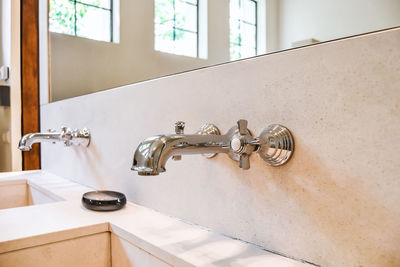 Close-up of faucet in bathroom