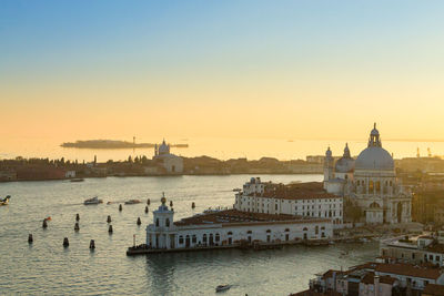 View of buildings in city at sunset