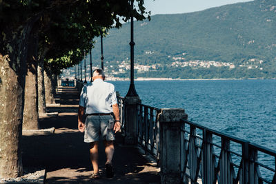 Man standing by sea against sky