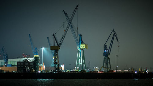 Cranes at commercial dock at night