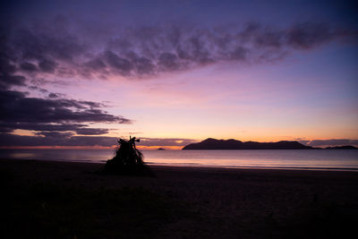 Scenic view of beach against sky during sunset