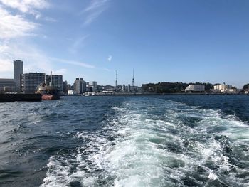 Scenic view of sea and buildings against sky