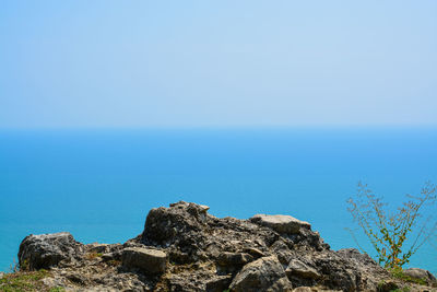 Scenic view of sea with rocks in foreground