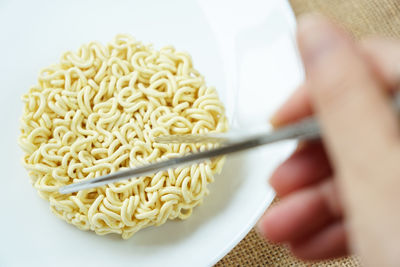 Close-up of hand holding pasta
