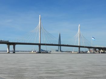 Low angle view of bridge over sea against clear sky