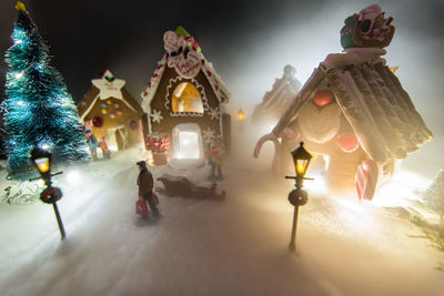 Statue in illuminated christmas lights at night