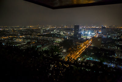 High angle view of city lit up at night