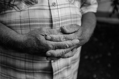 Close-up of hand holding hands against blurred background