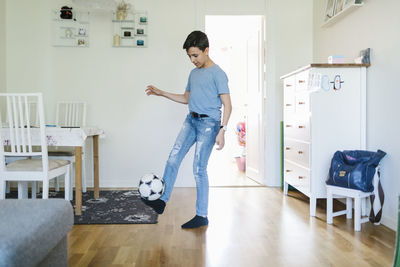 Boy playing football at home