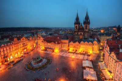 High angle view of illuminated buildings in city at dusk