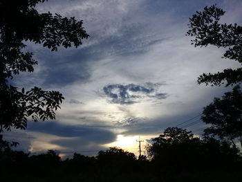 Low angle view of silhouette trees against sky at sunset