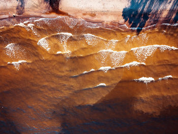 Aerial view of brown sea during sunset