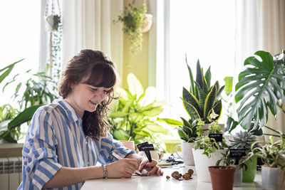 Young woman using mobile phone at home