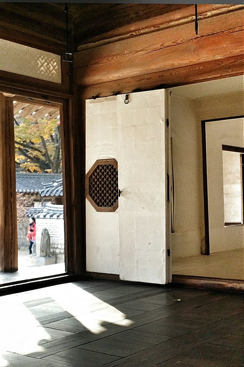 architecture, built structure, building exterior, door, entrance, indoors, empty, flooring, building, closed, absence, street, day, sunlight, shadow, window, corridor, the way forward, architectural column, column