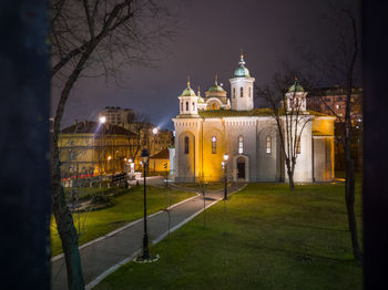 Illuminated buildings against sky at night