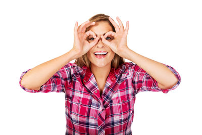 Portrait of cheerful woman gesturing against white background