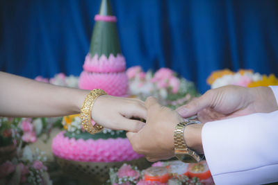 Close-up of couple holding hands 