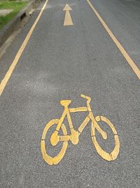 High angle view of arrow symbol on bicycle lane