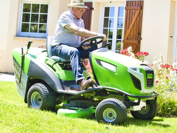 Side view of man sitting on grass