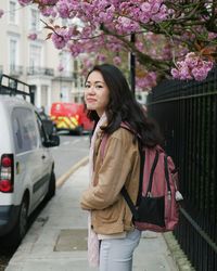 Young woman standing on street in city