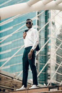 Full length of man standing against building in city