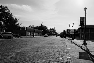 Street amidst buildings in city against sky