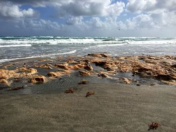 Scenic view of sea against cloudy sky