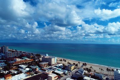 High angle view of buildings by sea against sky