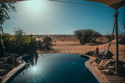 View of swimming pool against blue sky