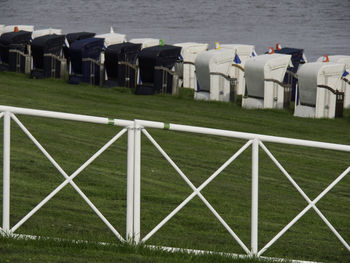 Row of hooded chairs on beach