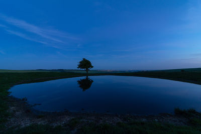 Scenic view of lake against blue sky