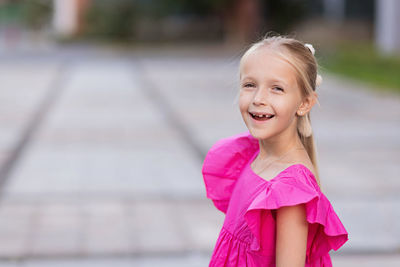 Portrait of young woman standing outdoors