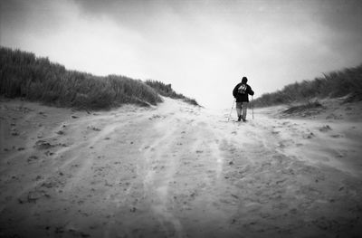 Full length of man walking on sand