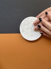 High angle view of hand holding ice cream on table