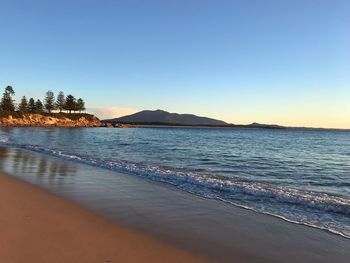 Scenic view of sea against clear sky during sunset