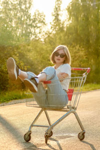Portrait of boy playing with shopping cart