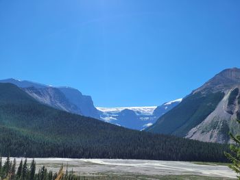 Scenic view of mountains against clear blue sky