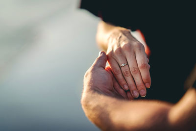 Close-up of couple hand holding hands