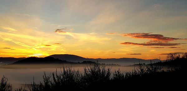 Scenic view of lake against sky during sunset