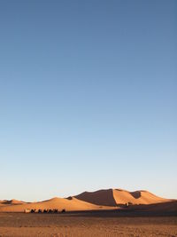Scenic view of desert landscape against clear sky