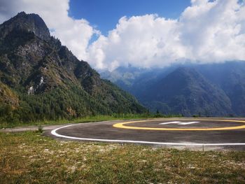 Road by mountain against sky